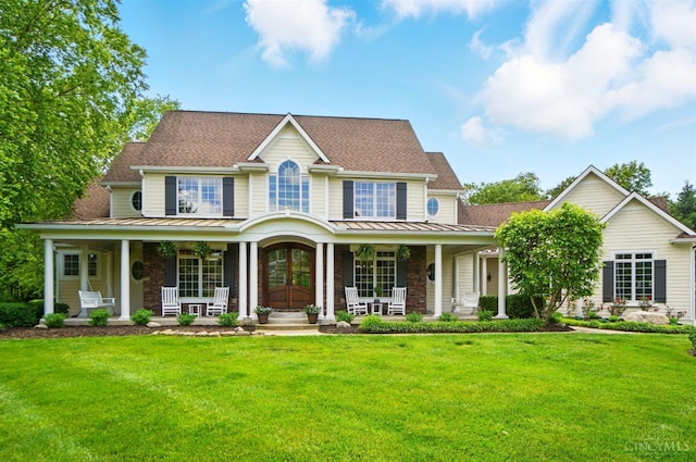 7757 Misty Meadows Ct, Harlan Twp, OH 45152 - view of front facade featuring covered porch, a standing seam roof, and a front yard