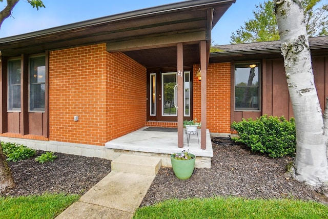 21 Garden Cir, Wilmington, OH 45177 - view of exterior entry with brick siding, covered porch, and a chimney