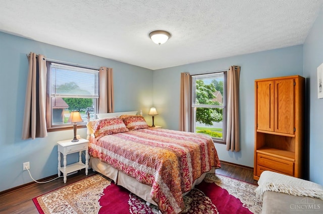 21 Garden Cir, Wilmington, OH 45177 - bedroom with wood finished floors, baseboards, and a textured ceiling
