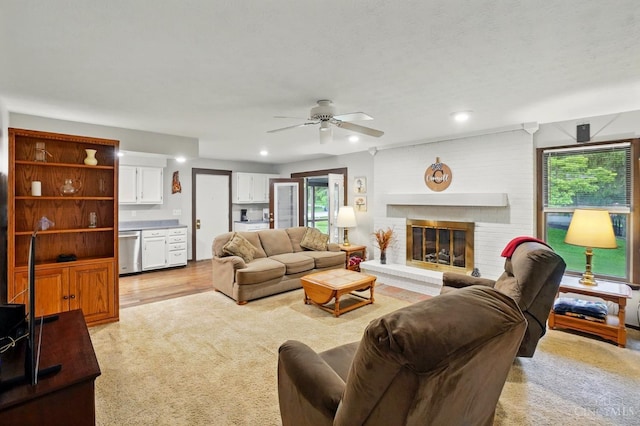 21 Garden Cir, Wilmington, OH 45177 - living area with plenty of natural light, a ceiling fan, a brick fireplace, and light colored carpet