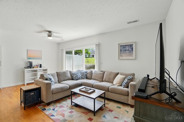 943 Steamboat Dr Unit 204, Union Twp, OH 45244 - living area featuring a textured ceiling, light wood finished floors, and a ceiling fan