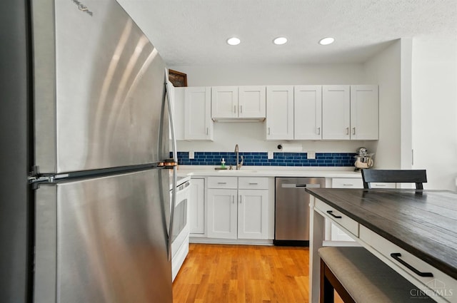 943 Steamboat Dr Unit 204, Union Twp, OH 45244 - kitchen with stainless steel appliances, a sink, recessed lighting, backsplash, and white cabinets