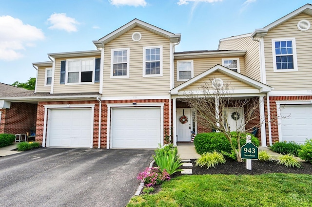 943 Steamboat Dr Unit 204, Union Twp, OH 45244 - townhome / multi-family property featuring asphalt driveway, brick siding, and an attached garage