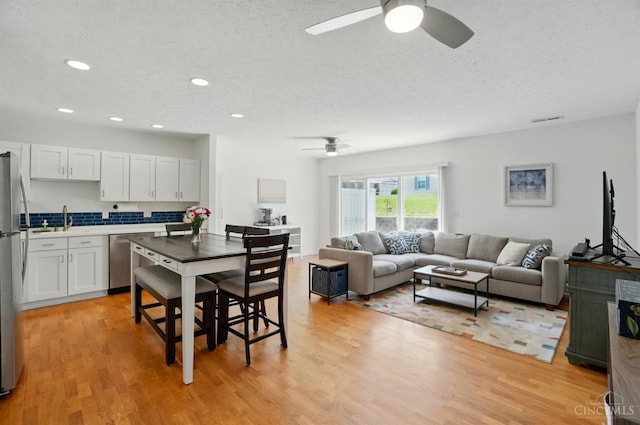 943 Steamboat Dr Unit 204, Union Twp, OH 45244 - dining space with ceiling fan, light wood-style floors, a textured ceiling, and recessed lighting