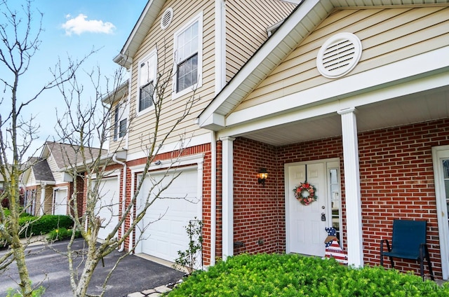 943 Steamboat Dr Unit 204, Union Twp, OH 45244 - property entrance with brick siding, driveway, and an attached garage