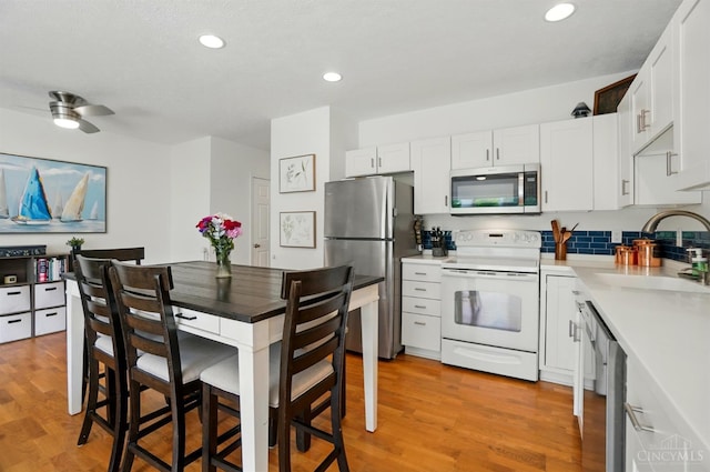 943 Steamboat Dr Unit 204, Union Twp, OH 45244 - kitchen with appliances with stainless steel finishes, a sink, light wood finished floors, light countertops, and recessed lighting