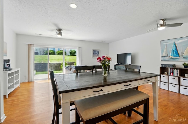 943 Steamboat Dr Unit 204, Union Twp, OH 45244 - dining room featuring ceiling fan, a textured ceiling, and light wood-style floors