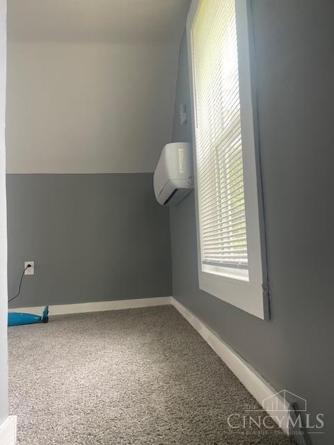 4 Cottage Ct, Anderson Twp, OH 45230 - bonus room featuring a wall unit AC, carpet flooring, and baseboards