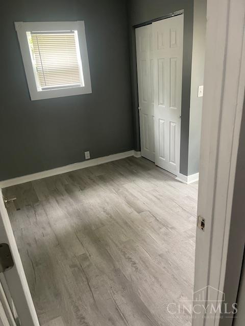 4 Cottage Ct, Anderson Twp, OH 45230 - unfurnished bedroom with wood finished floors, baseboards, and a closet