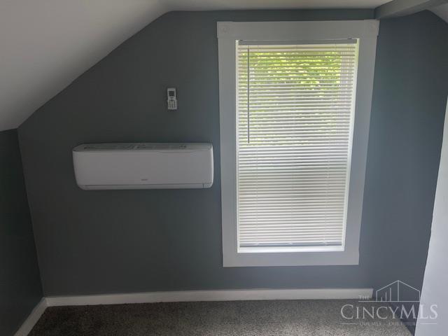 4 Cottage Ct, Anderson Twp, OH 45230 - additional living space featuring a wall mounted AC, carpet, vaulted ceiling, and baseboards
