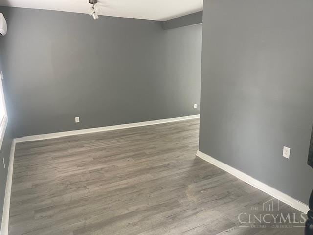 4 Cottage Ct, Anderson Twp, OH 45230 - unfurnished room featuring baseboards, wood finished floors, and a wall mounted AC