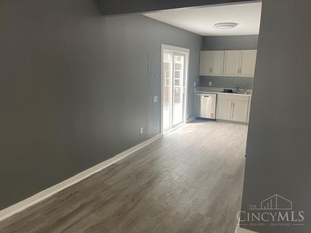 4 Cottage Ct, Anderson Twp, OH 45230 - kitchen with stainless steel dishwasher, wood finished floors, baseboards, and light countertops
