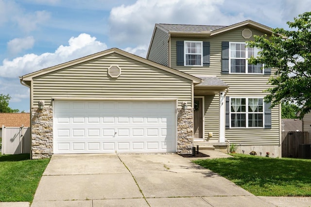 1240 Carriage Hill Ln, Hamilton, OH 45013 - view of front facade with concrete driveway, an attached garage, and stone siding