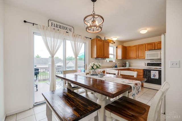1240 Carriage Hill Ln, Hamilton, OH 45013 - dining room with light tile patterned floors and a chandelier