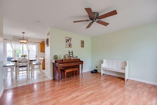 1240 Carriage Hill Ln, Hamilton, OH 45013 - sitting room with a chandelier, light wood-style flooring, a ceiling fan, and baseboards