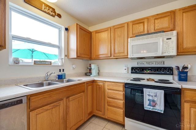 1240 Carriage Hill Ln, Hamilton, OH 45013 - kitchen with white microwave, electric range oven, dishwasher, a sink, and light tile patterned floors