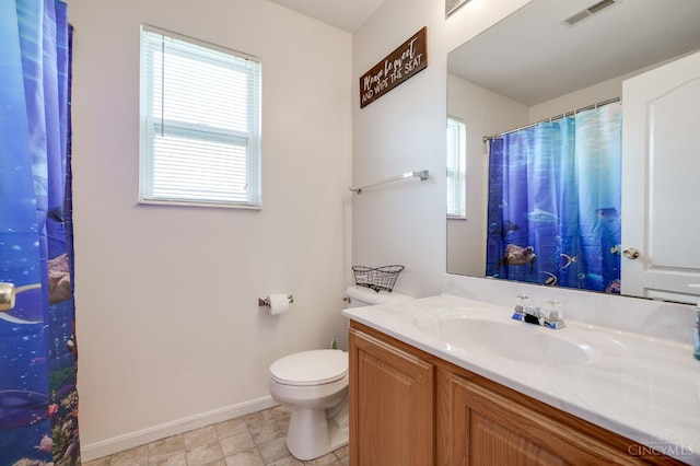 1240 Carriage Hill Ln, Hamilton, OH 45013 - bathroom featuring baseboards, vanity, plenty of natural light, and toilet