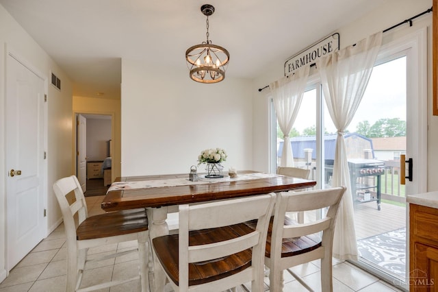 1240 Carriage Hill Ln, Hamilton, OH 45013 - dining room with light tile patterned flooring and a chandelier
