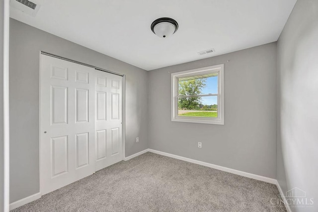 8486 US Route 127, West Manchester, OH 45382 - unfurnished bedroom with carpet flooring, baseboards, and a closet