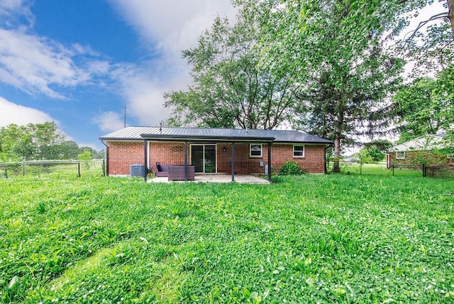 8486 US Route 127, West Manchester, OH 45382 - back of property with a patio, brick siding, a fenced backyard, and central AC unit