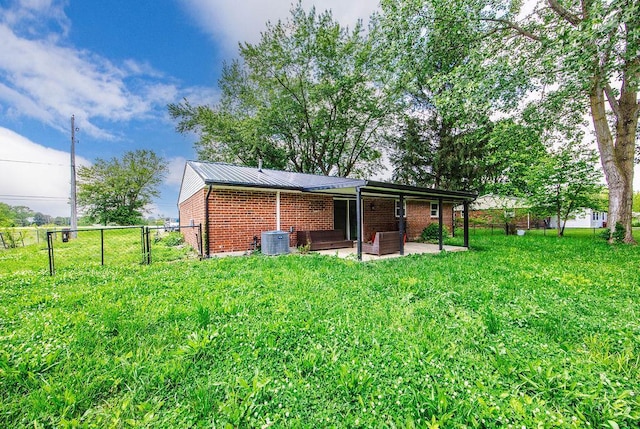 8486 US Route 127, West Manchester, OH 45382 - back of property with brick siding, a patio area, cooling unit, and metal roof