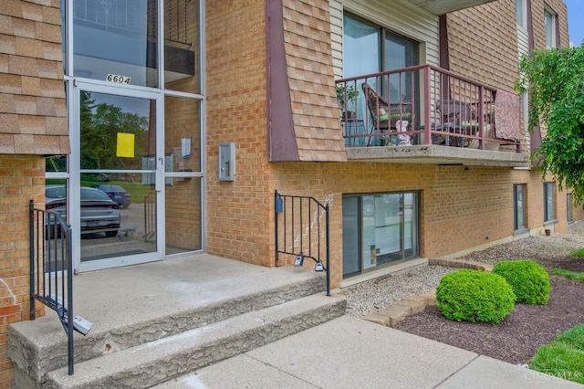 6604 Hearne Rd Unit 58, Green Twp, OH 45248 - view of exterior entry with brick siding and a balcony