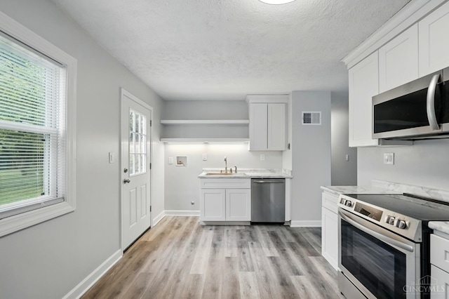 3195 Deshler, Colerain Twp, OH 45251 - kitchen featuring stainless steel appliances, open shelves, a sink, white cabinets, and a textured ceiling