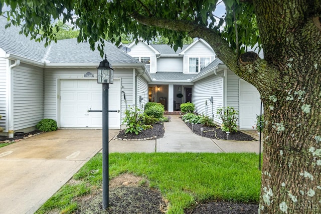 7638 Lake Pointe, Hamilton Twp, OH 45039 - traditional home featuring roof with shingles, an attached garage, and driveway