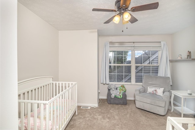 7638 Lake Pointe, Hamilton Twp, OH 45039 - carpeted bedroom with a textured ceiling, baseboards, a nursery area, and a ceiling fan