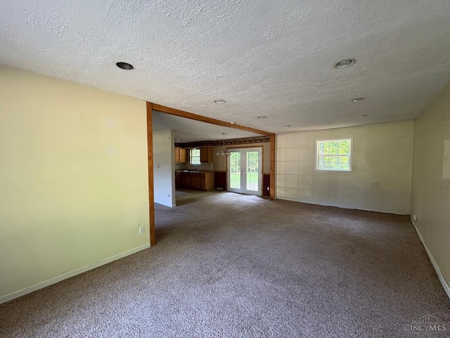 2307 Wilshire Cir, Stonelick Twp, OH 45122 - unfurnished living room featuring a textured ceiling, french doors, and carpet