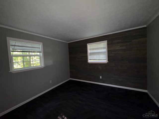 2307 Wilshire Cir, Stonelick Twp, OH 45122 - empty room with wooden walls, healthy amount of natural light, ornamental molding, and an accent wall