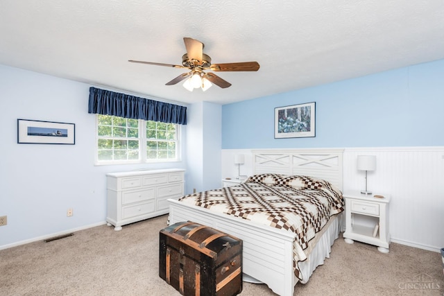 1627 Braintree Dr, Anderson Twp, OH 45255 - bedroom with light colored carpet, a wainscoted wall, and a ceiling fan