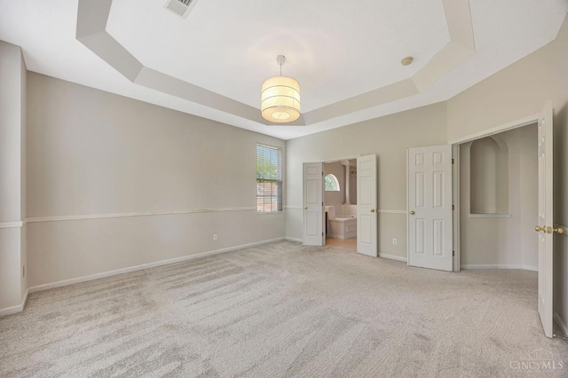 9298 Greenery Ct, Deerfield Twp, OH 45140 - unfurnished bedroom with a raised ceiling, carpet, baseboards, and ensuite bath