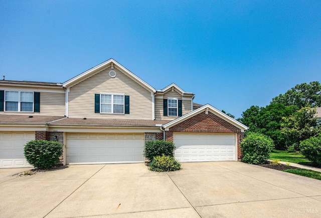 9298 Greenery Ct, Deerfield Twp, OH 45140 - view of front of property with brick siding, concrete driveway, and an attached garage