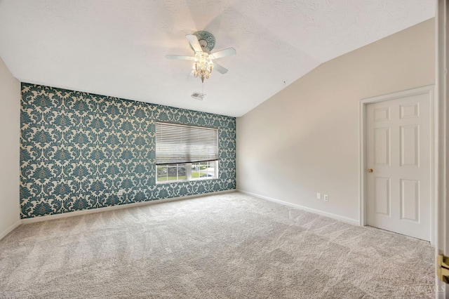 9298 Greenery Ct, Deerfield Twp, OH 45140 - carpeted empty room featuring wallpapered walls, baseboards, a ceiling fan, lofted ceiling, and an accent wall