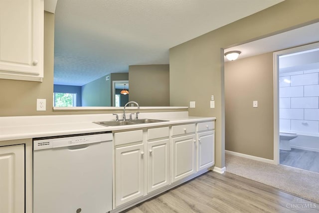 715 Castlegate Ln Unit 102, Springfield Twp, OH 45231 - kitchen featuring dishwasher, a sink, white cabinetry, light countertops, and a textured ceiling