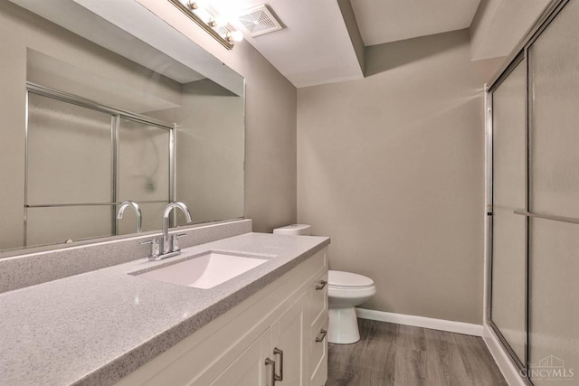 715 Castlegate Ln Unit 102, Springfield Twp, OH 45231 - full bath featuring a stall shower, vanity, toilet, and wood finished floors