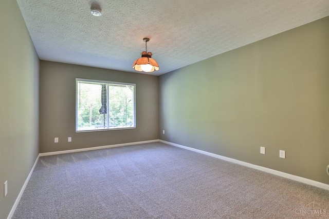 715 Castlegate Ln Unit 102, Springfield Twp, OH 45231 - spare room with carpet flooring, a textured ceiling, and baseboards