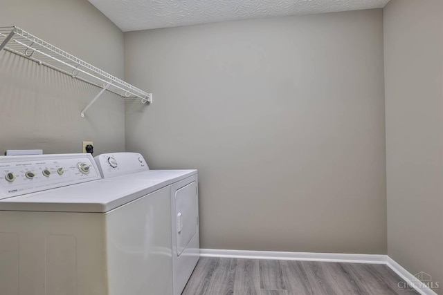 715 Castlegate Ln Unit 102, Springfield Twp, OH 45231 - washroom featuring washer and dryer, wood finished floors, and baseboards