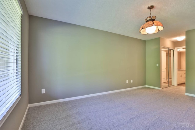 715 Castlegate Ln Unit 102, Springfield Twp, OH 45231 - unfurnished room featuring carpet, baseboards, and a textured ceiling