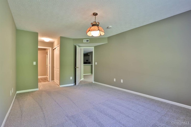 715 Castlegate Ln Unit 102, Springfield Twp, OH 45231 - spare room featuring a textured ceiling, baseboards, and carpet floors