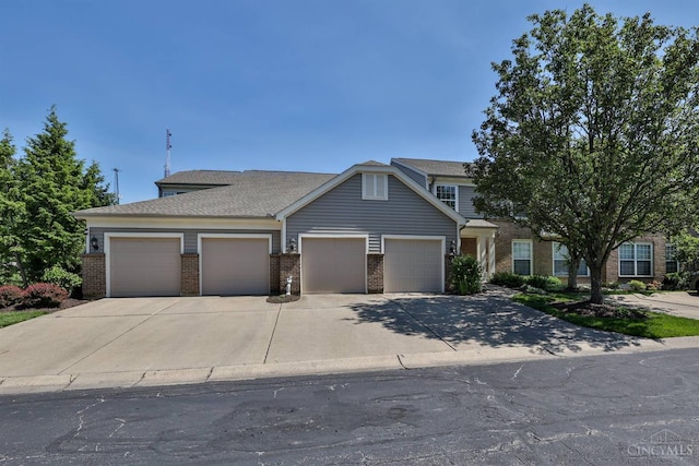 715 Castlegate Ln Unit 102, Springfield Twp, OH 45231 - view of front facade featuring brick siding, an attached garage, and driveway