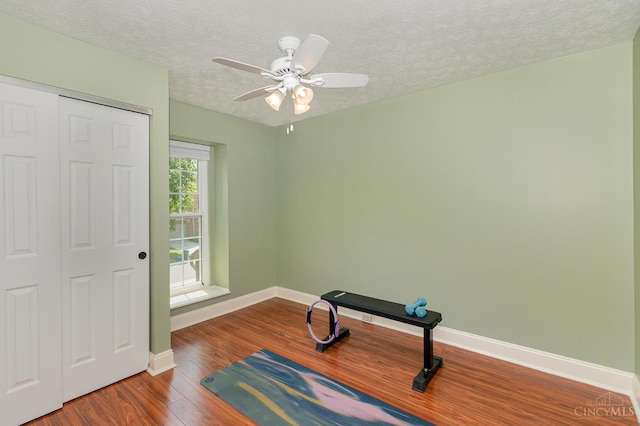 1732 Emerald Glade Ln Unit 6D, Anderson Twp, OH 45255 - exercise room featuring wood finished floors, baseboards, a textured ceiling, and ceiling fan
