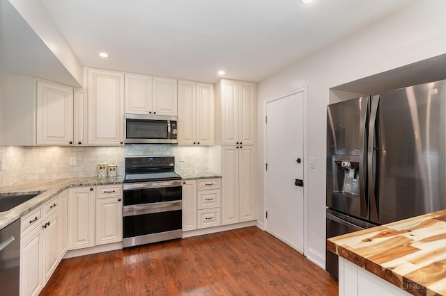 1732 Emerald Glade Ln Unit 6D, Anderson Twp, OH 45255 - kitchen featuring appliances with stainless steel finishes, tasteful backsplash, dark wood-style floors, recessed lighting, and light stone counters