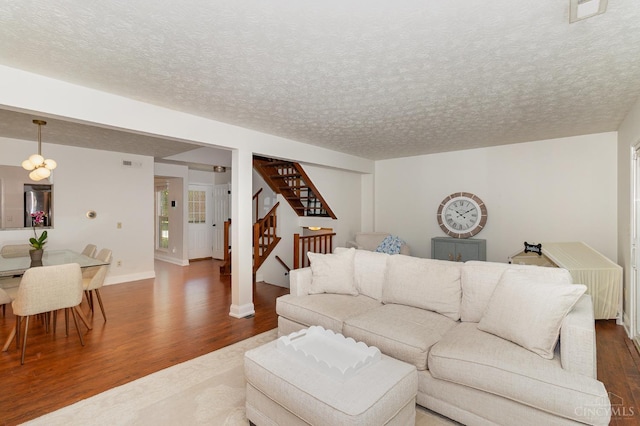 1732 Emerald Glade Ln Unit 6D, Anderson Twp, OH 45255 - living room featuring dark wood finished floors, stairs, a textured ceiling, and baseboards