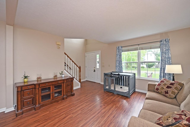 557 Hamblin Dr, Union Twp, OH 45255 - living area with stairs, wood finished floors, and baseboards