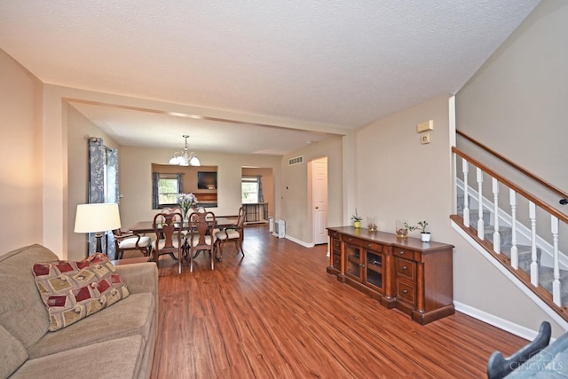 557 Hamblin Dr, Union Twp, OH 45255 - living area with dark wood-style floors, a chandelier, stairs, and baseboards
