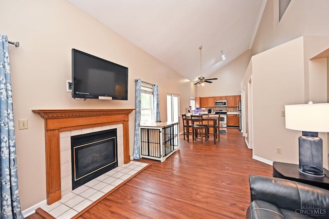 557 Hamblin Dr, Union Twp, OH 45255 - living room with wood finished floors, baseboards, a tile fireplace, a ceiling fan, and high vaulted ceiling