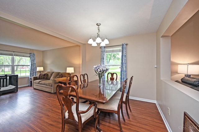 557 Hamblin Dr, Union Twp, OH 45255 - dining space with a chandelier, healthy amount of natural light, dark wood-style flooring, and baseboards