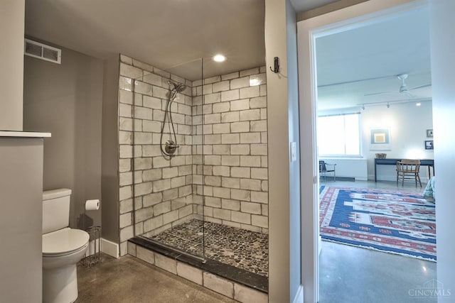2401 Ingleside Ave Unit 10D, Cincinnati, OH 45206 - bathroom featuring concrete flooring, a tile shower, toilet, and baseboards